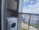 Washing machine on a balcony with a city view