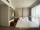 Modern bedroom with large window, double bed, and vanity area