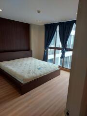 Bedroom with large windows and wooden floor