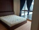 Bedroom with large windows and wooden floor