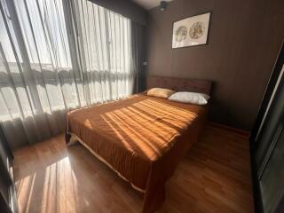 Cozy bedroom with a large window and double bed