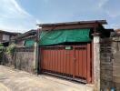 Front view of a single-story house with a gated entrance