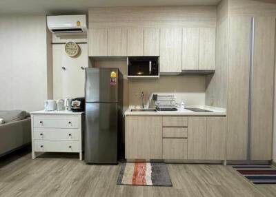 Modern kitchen with light wood cabinets and appliances
