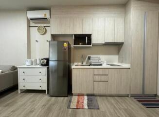 Modern kitchen with light wood cabinets and appliances