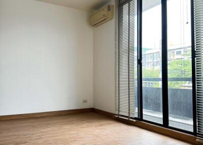 Living room with wooden flooring and large window