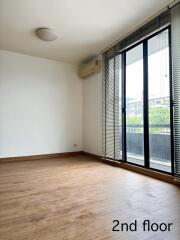 Living room with wooden flooring and large window