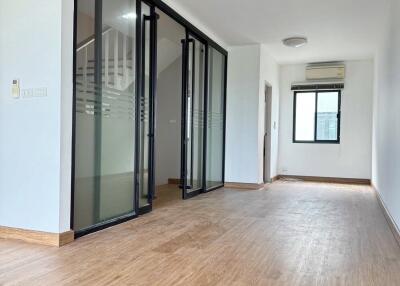 Spacious living room with wooden flooring and glass sliding doors