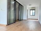 Spacious living room with wooden flooring and glass sliding doors