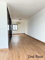 Spacious second-floor bedroom with wooden flooring