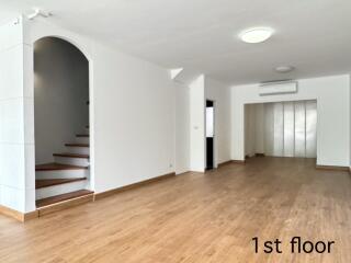 Spacious main living area with staircase and wooden flooring