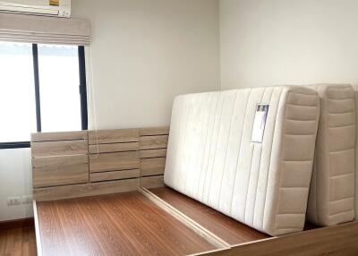 Bedroom on 4th floor with bed frame and stacked mattresses