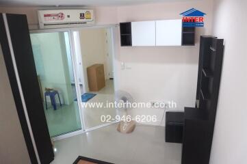 Modern living room with built-in shelves and air conditioning unit