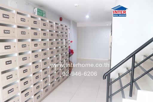 Mailboxes in a hallway with a staircase