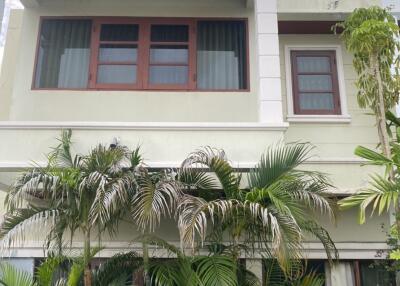 Front view of a modern two-story house with plants