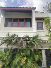 Front view of a modern two-story house with plants