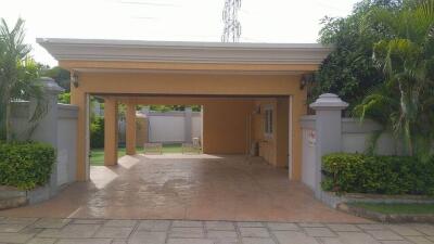 Covered garage with surrounding greenery