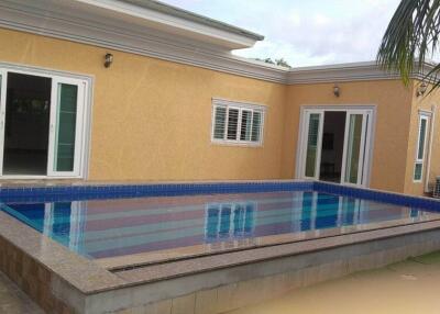 Swimming pool in the backyard of a house with spacious patio area