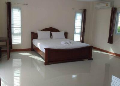 Spacious Bedroom with Queen Bed and Large Windows