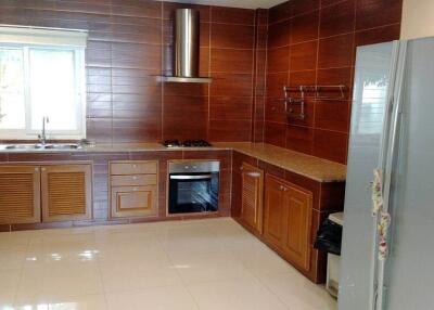 Modern kitchen with wooden cabinets and stainless steel appliances