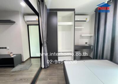 Modern bedroom with built-in wardrobe and air conditioning