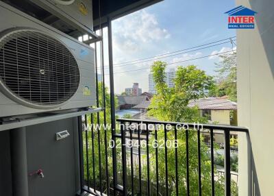 Balcony with air conditioning unit and view of surrounding neighborhood