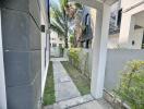 Walkway alongside building with garden