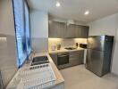 Modern kitchen with stainless steel appliances and gray cabinets