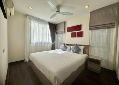 Well-lit bedroom with a large bed and modern decor