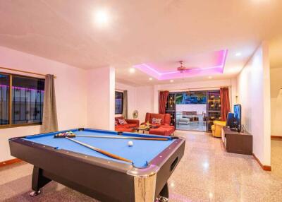 Spacious living area with pool table and seating arrangement