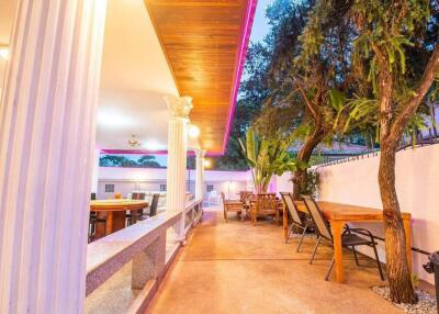 Elegant outdoor dining space with columns and ceiling lights