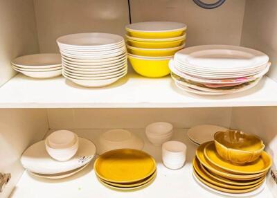 Kitchen cabinet with neatly stacked plates and bowls