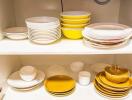 Kitchen cabinet with neatly stacked plates and bowls