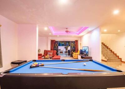 Living room with pool table and seating area