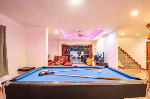 Living room with pool table and seating area