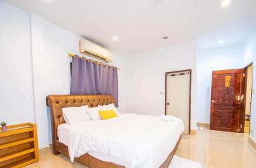 Spacious and bright bedroom with a large bed and air conditioning