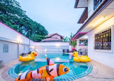 Outdoor swimming pool with inflatable toys