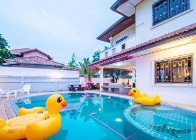 Outdoor pool with inflatable toys at a residential property