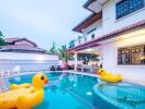 Outdoor pool with inflatable toys at a residential property