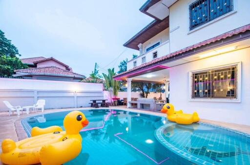 Outdoor pool with inflatable toys at a residential property