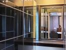Walk-in closet with mirrored sliding doors and wooden flooring