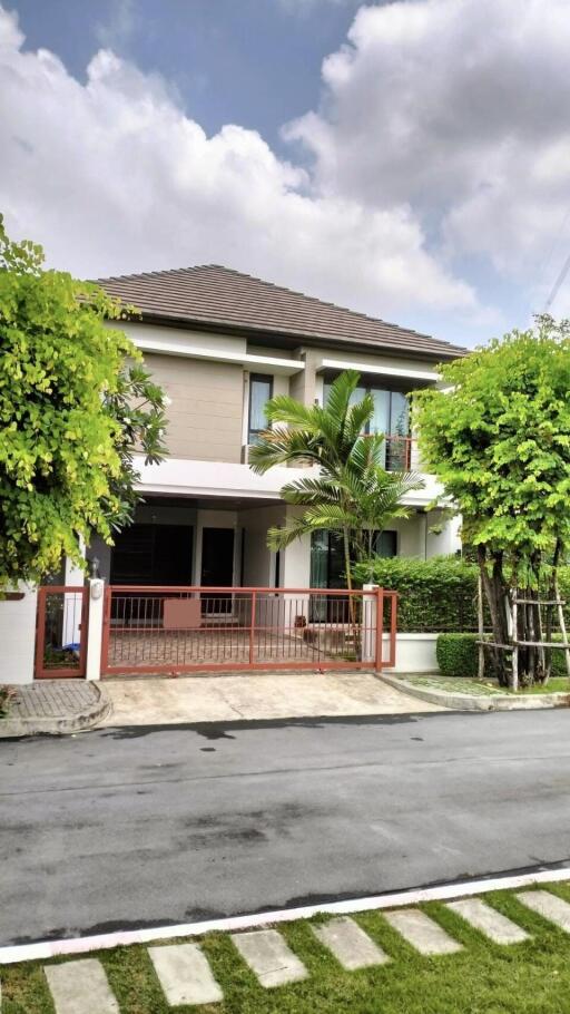 Two-story house with a landscaped front yard and driveway