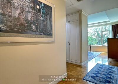 Hallway with hardwood floor and artwork