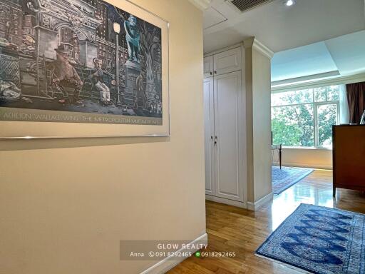 Hallway with hardwood floor and artwork