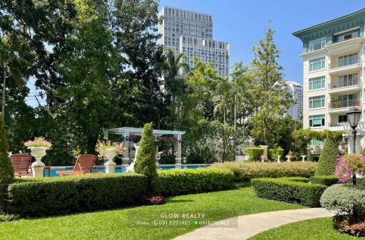 Beautiful landscaped garden with a pool and seating area at a residential property