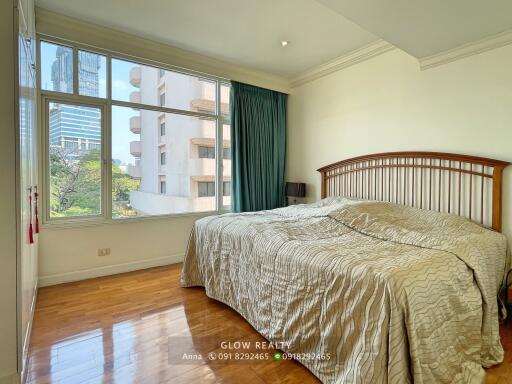 Cozy bedroom with large window and city view