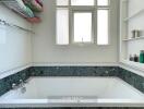 Bathroom with bathtub, window, and shelving