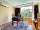 Home office with a desk, chairs, and a large window with a view