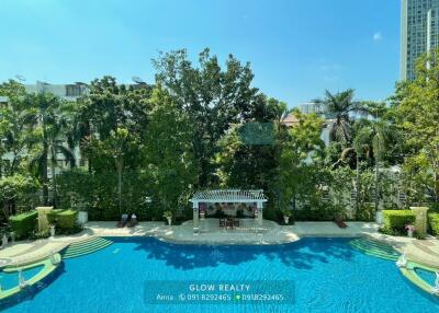 Swimming pool area with pergola and surrounding greenery