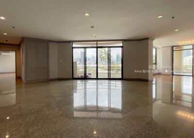 Spacious living area with large windows and balcony access