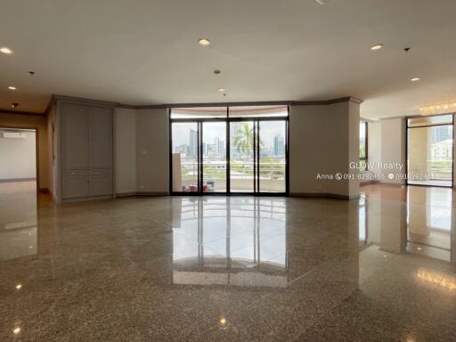 Spacious living area with large windows and balcony access